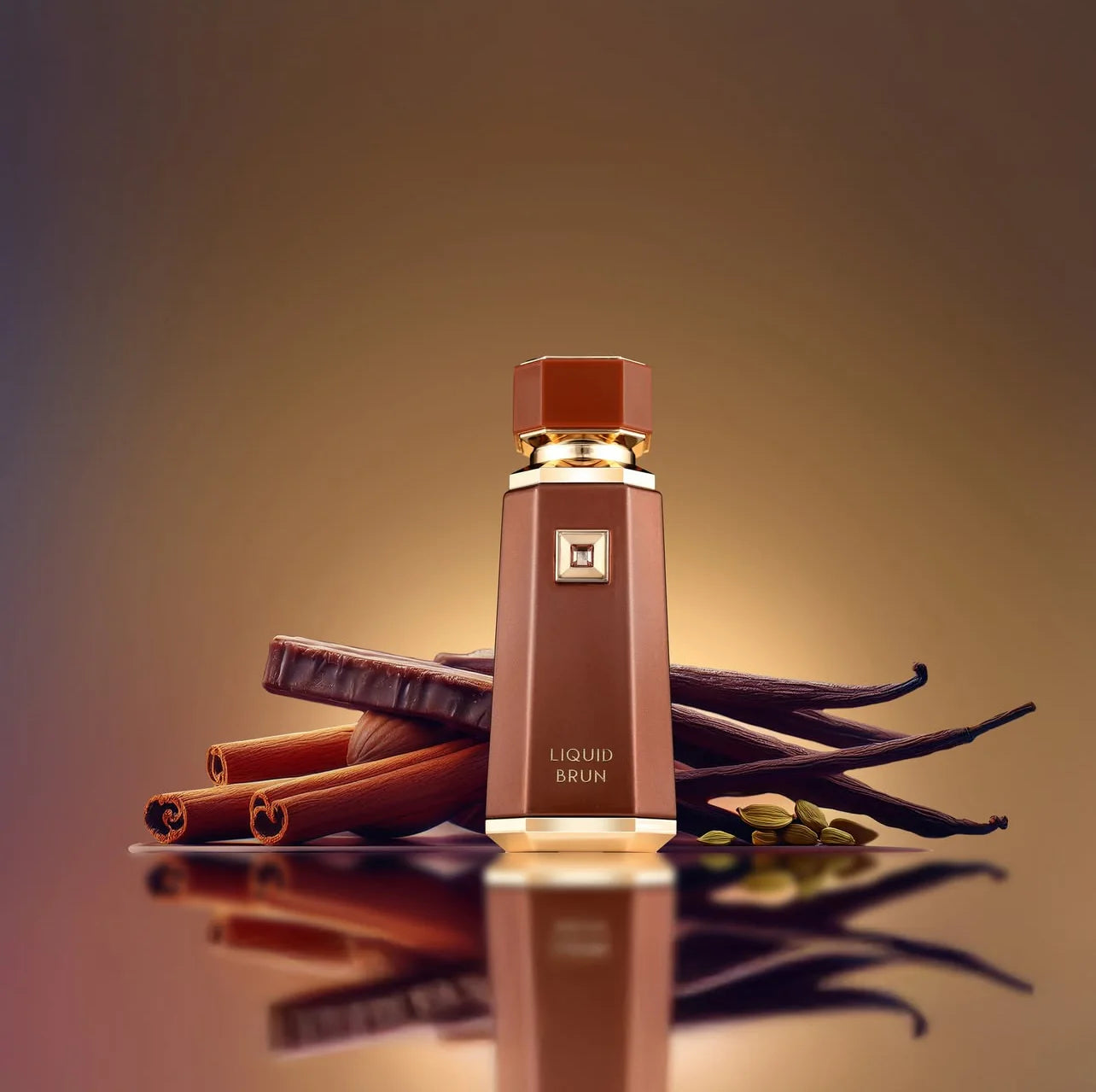 Brown bottle labeled 'LIQUID BRUN' with cinnamon sticks and vanilla beans on a reflective surface.